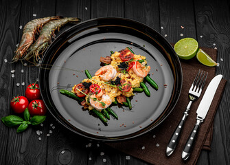 Omelet with shrimp, caviar and grilled tomatoes on a bed of green beans and bacon