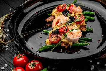 Omelet with shrimp, caviar and grilled tomatoes on a bed of green beans and bacon