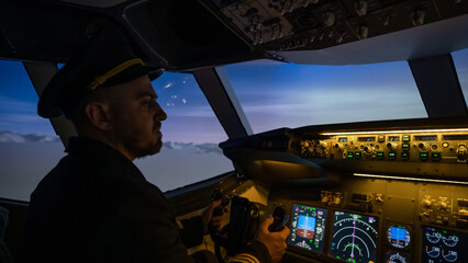 A man is studying to be a pilot in an aircraft simulator. 