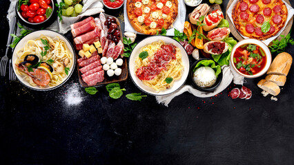 Italian food dishes on dark background.