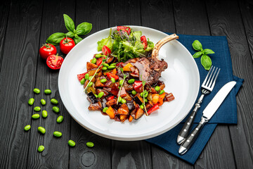 grilled pork steak with a bone in a sweet honey glaze and vegetable stew with green beans