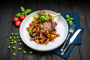 grilled pork steak with a bone in a sweet honey glaze and vegetable stew with green beans