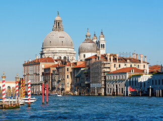 Naklejka premium Grand canal in Venice with old houses and the church Santa Maria della Salute in the background