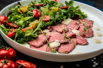 Italian Cuisine - Vitello Tonnato. Cold Sliced Veal with salad and Creamy Sauce