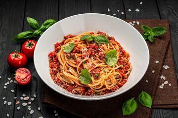 Traditional italian spaghetti bolognese on a dark background