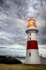 Fototapeta na wymiar Low Head Lighthouse as a storm rolls in. Situated on the mouth of the Tamar River, this is one of the oldest lighthouses and pilot stations in Tasmania