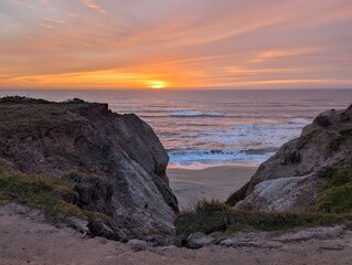 sunset over the Pacific Ocean, sunset in Half Moon Bay State Beach cliff side landscape
