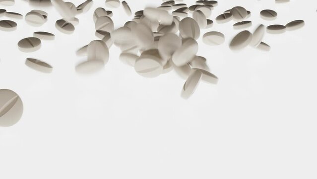 White pills fall onto a white, illuminated surface.