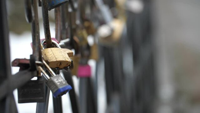 Padlock on the fence as a symbol of love and mutual feelings of the newlyweds.