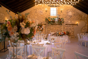Romantic boho main table. Wedding decor with dried flowers floristry, stumps, and candles, boho style. Pampas grass