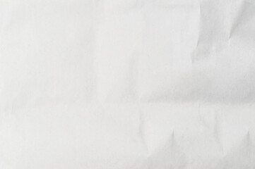 Wrinkled or crumpled white stencil paper or tissue after use in toilet or restroom with large copy space used for background texture in decorative art work