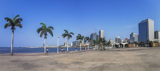 Panoramic view at the Luanda bay and Luanda marginal, pedestrian pathway with tropical palm trees,...