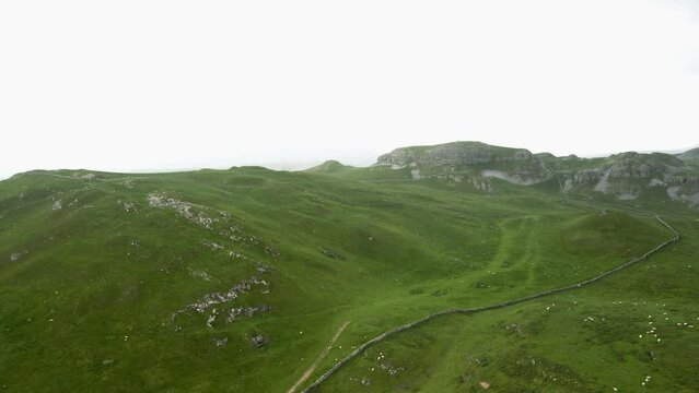 Aerial Drone Footage over the Beautiful Yorkshire Dales scenery village of Malham, Rolling Hill in Countryside of North Yorkshire, UK: 4K

