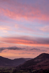 Beautiful colorful Winter sunset landscape over Skiddaw range looking towards Bassenthwaite Lake in Lake District