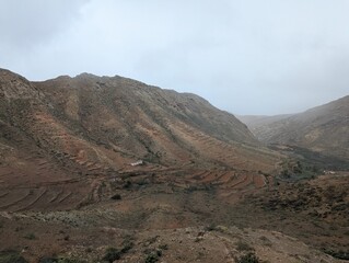 Landschaft im Parque Rural de Betancuria, auf Fuerteventura bei bewölktem Himmel und regnerischem Wetter