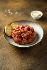 Homemade steak tartare with baguette bread