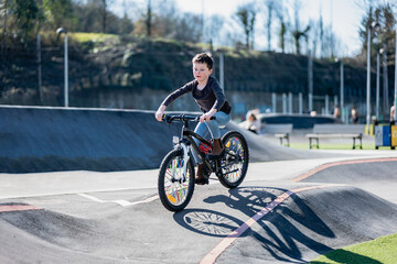 Child riding a bicycle on a skating rink