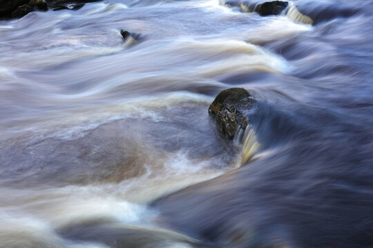Close up image of a stream showing motion blur, Rookhope Burn, County Durham, England, UK.