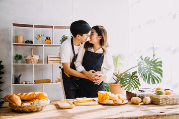 Obraz na płótnie Canvas In Kitchen: Perfectly Happy Couple Preparing Healthy Food, Lots of Vegetables. Man Juggles with Fruits, Makes Her Girlfriend Laugh. Lovely People in Love Have Fun