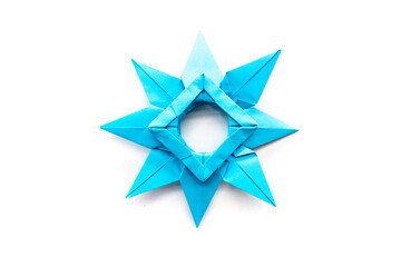 blue paper star on a white background. origami. papercraft. needlework