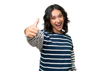 Young Argentinian woman over isolated background with thumbs up because something good has happened
