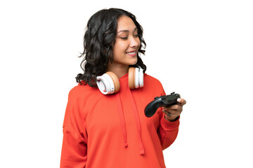 Young Argentinian woman playing with a video game controller over isolated background looking to the side and smiling © luismolinero