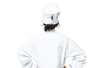 Young chef Argentinian woman over isolated background in back position