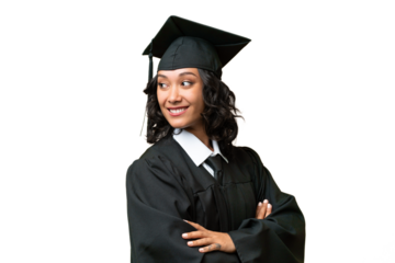 Young university graduate Argentinian woman over isolated background with arms crossed and happy