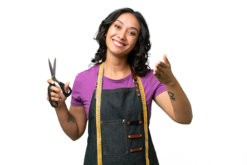Young seamstress argentinian woman over isolated background shaking hands for closing a good deal