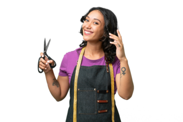 Young seamstress argentinian woman over isolated background saluting with hand with happy expression