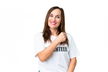 Middle age volunteer woman over isolated chroma key background celebrating a victory