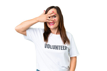 Fototapeta premium Middle age volunteer woman over isolated chroma key background covering eyes by hands and smiling