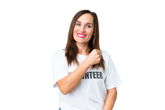 Middle age volunteer woman over isolated chroma key background celebrating a victory