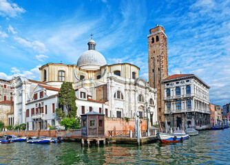 Naklejka premium Venetian canal with boats and Santa Maria Gloriosa dei Frari Church in bright summer day, Venice