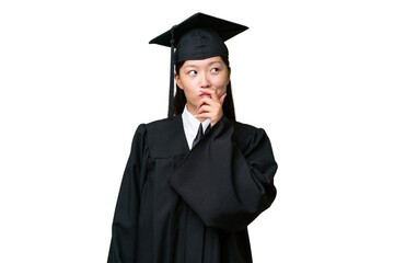 Young university graduate Asian woman over isolated background having doubts and with confuse face expression