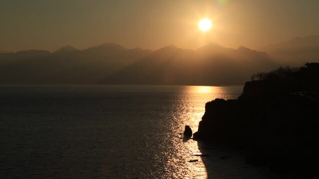 Seascape, mountains and sea at sunset