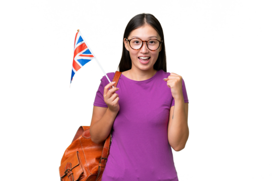 Young Asian woman holding an United Kingdom flag over isolated background celebrating a victory in winner position