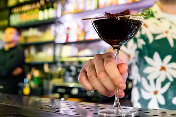 man hand bartender making cocktail in glass on the bar counter