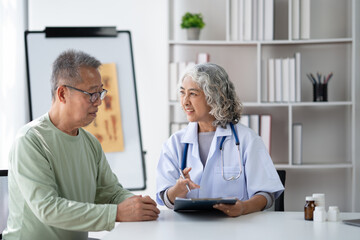 Fototapeta premium Serious middle-aged female doctor pediatrician talk with male patient, examine and discussing about the illness.