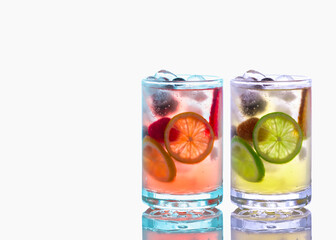 View of cocktails in crystal glass with ice cubes and   garnished with lime slices  isolated on white background. 
