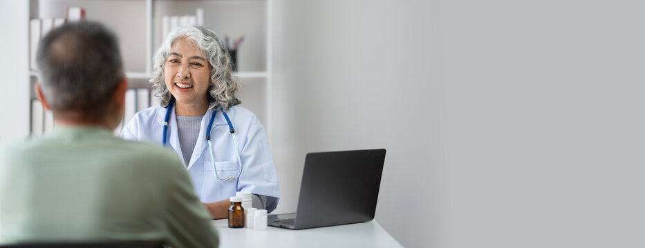 Serious middle-aged female doctor pediatrician talk with male patient, examine and discussing about the illness. - Powered by Adobe