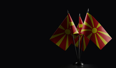 Small national flags of the Macedonia on a black background