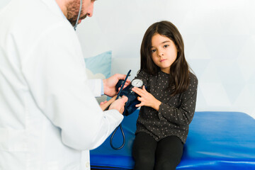 Sick young kid getting a medical check-up with a pediatrician