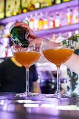 man hand bartender making cocktail in glass on the bar counter