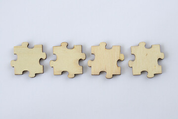Mock up of four blank wooden puzzles on a white background for your abbreviation text or design.