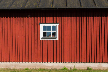 Traditional ancient old vintage red Swedish house from wood on a sunny day in summer. Stylish European private house.