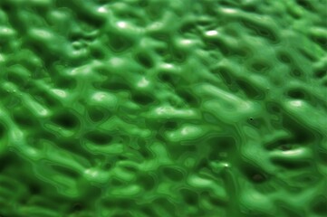 Green wet acrylic paint. Abstract background.