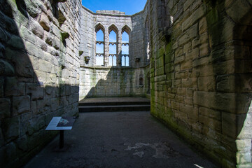 Inside ruined shell of Warkworth Castle chapel in Northumberland, UK