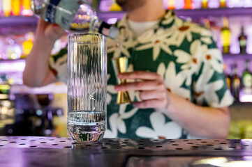 man bartender making cold gin tonic cocktail in bar