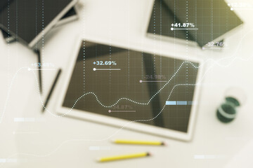 Double exposure of abstract creative statistics data hologram and digital tablet on background, top view, statistics and analytics concept